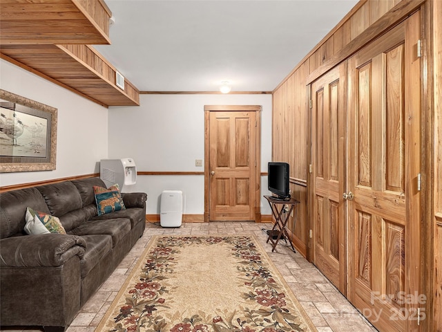 505 Middle Top Loop, Maggie Valley, NC 28751 - living area featuring crown molding, baseboards, and light stone finish floors