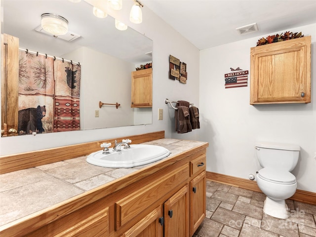505 Middle Top Loop, Maggie Valley, NC 28751 - bathroom with stone tile floors, baseboards, vanity, and toilet