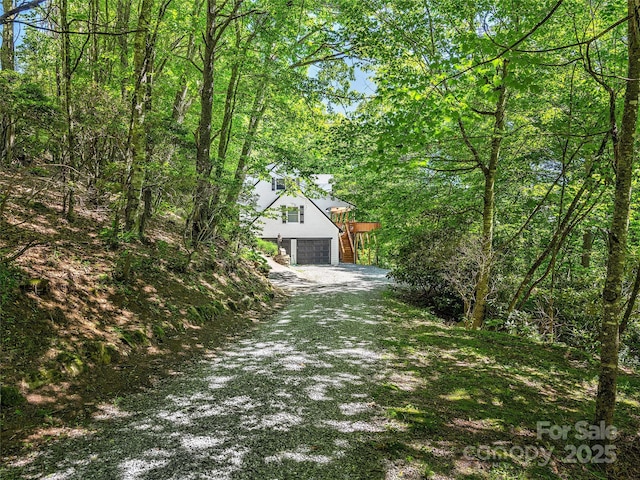 505 Middle Top Loop, Maggie Valley, NC 28751 - view of front facade featuring a garage, driveway, and a wooded view