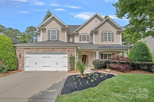 1849 Still Water Ln, Indian Land, SC 29707 - view of front of home with driveway, a garage, stone siding, roof with shingles, and a front lawn