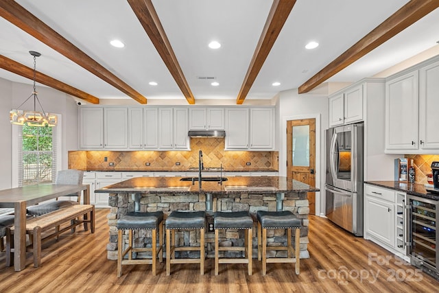 1849 Still Water Ln, Indian Land, SC 29707 - kitchen featuring smart refrigerator, wine cooler, wood finished floors, decorative backsplash, and beamed ceiling