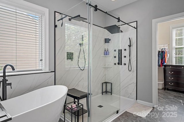 1849 Still Water Ln, Indian Land, SC 29707 - bathroom with marble look tiles, a soaking tub, a marble finish shower, and baseboards