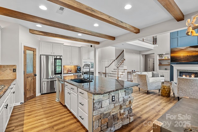 1849 Still Water Ln, Indian Land, SC 29707 - kitchen featuring stainless steel appliances, a sink, light wood-style flooring, dark stone counters, and recessed lighting