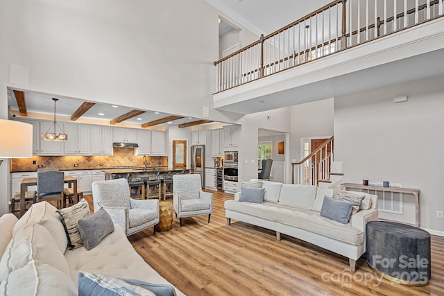 1849 Still Water Ln, Indian Land, SC 29707 - living area featuring light wood finished floors, stairway, a high ceiling, beamed ceiling, and recessed lighting