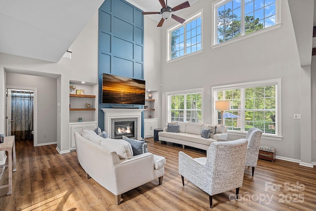 1849 Still Water Ln, Indian Land, SC 29707 - living area featuring a towering ceiling, baseboards, wood finished floors, a ceiling fan, and healthy amount of natural light