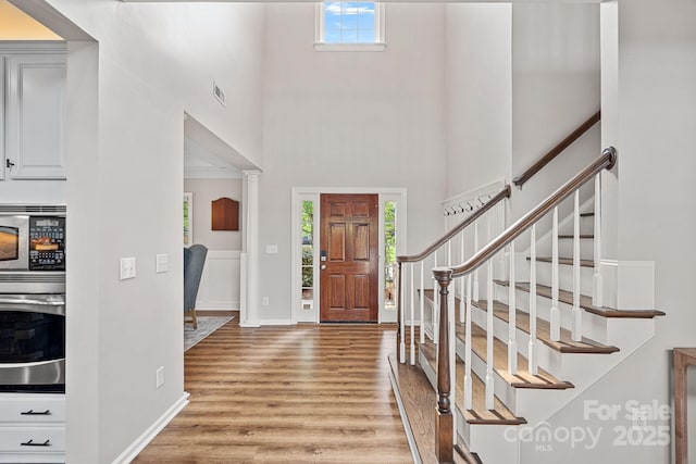 1849 Still Water Ln, Indian Land, SC 29707 - foyer featuring light wood-style floors, a high ceiling, stairs, and baseboards