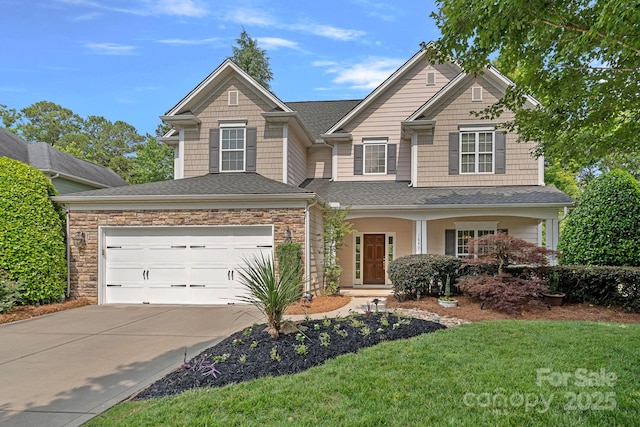1849 Still Water Ln, Indian Land, SC 29707 - view of front of house with concrete driveway, a garage, a shingled roof, stone siding, and a front yard