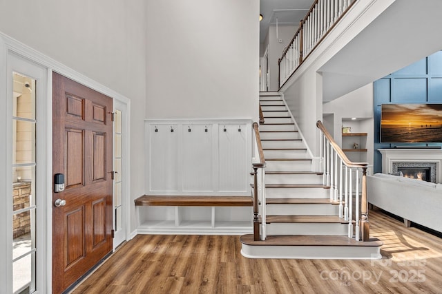 1849 Still Water Ln, Indian Land, SC 29707 - foyer with a towering ceiling, wood finished floors, stairs, and a glass covered fireplace