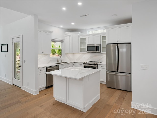 241 Millbrae Loop, Hendersonville, NC 28791 - kitchen with stainless steel appliances, a sink, light wood-style flooring, white cabinetry, and recessed lighting