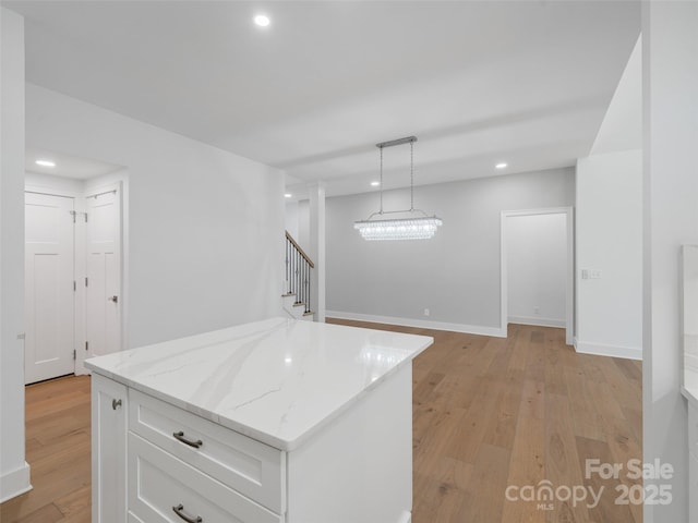241 Millbrae Loop, Hendersonville, NC 28791 - kitchen featuring white cabinets, light wood finished floors, recessed lighting, light stone counters, and a center island