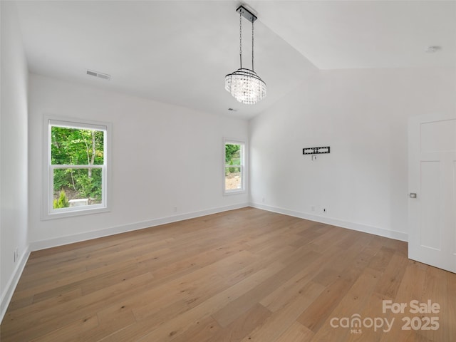 241 Millbrae Loop, Hendersonville, NC 28791 - spare room featuring light wood finished floors, plenty of natural light, lofted ceiling, baseboards, and a chandelier