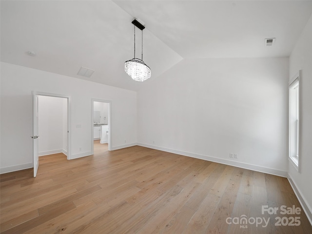 241 Millbrae Loop, Hendersonville, NC 28791 - unfurnished room featuring lofted ceiling, light wood-style flooring, a chandelier, and baseboards