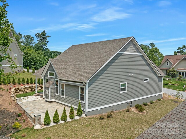 241 Millbrae Loop, Hendersonville, NC 28791 - view of property exterior with a patio area, roof with shingles, and a lawn