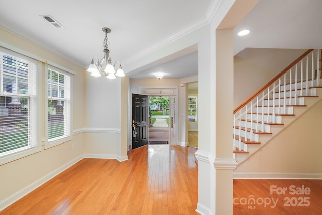 2065 Gable Way Ln, Matthews, NC 28104 - entrance foyer featuring hardwood / wood-style floors, a chandelier, plenty of natural light, crown molding, and stairway