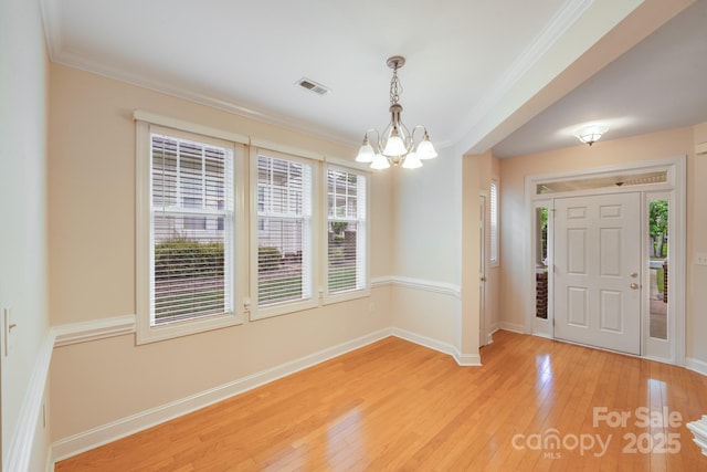 2065 Gable Way Ln, Matthews, NC 28104 - foyer entrance featuring a chandelier, light wood-style flooring, and ornamental molding