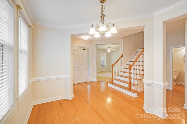 2065 Gable Way Ln, Matthews, NC 28104 - foyer entrance featuring a chandelier, light wood-type flooring, stairway, ornamental molding, and ceiling fan