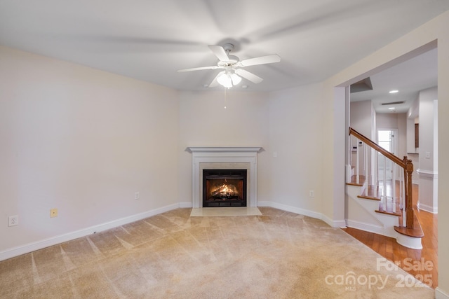 2065 Gable Way Ln, Matthews, NC 28104 - unfurnished living room featuring ceiling fan, stairway, a fireplace with flush hearth, and carpet floors