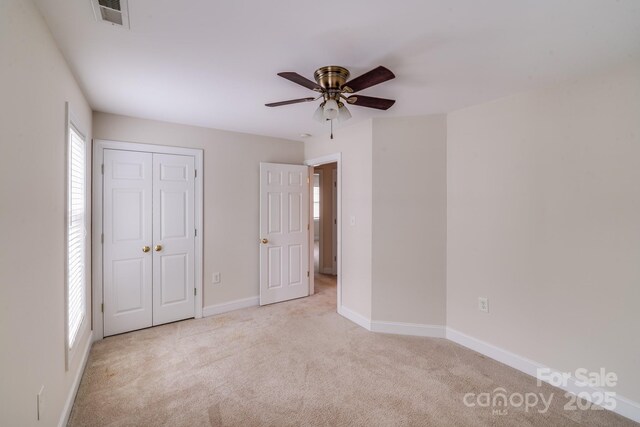 2065 Gable Way Ln, Matthews, NC 28104 - unfurnished bedroom with carpet, a closet, and ceiling fan