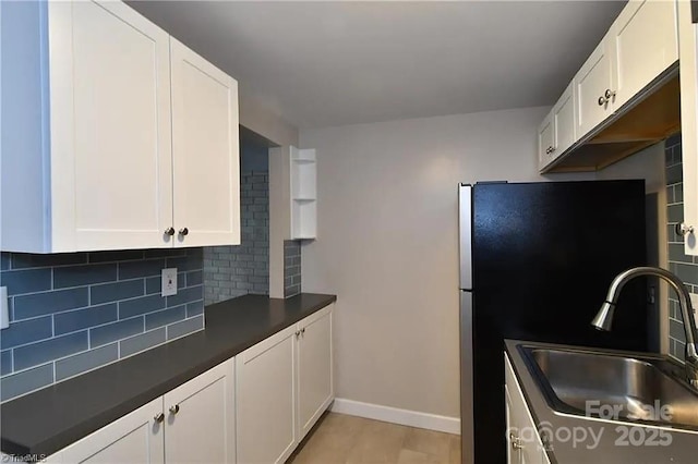 1807 S Hawthorne Rd, Winston Salem, NC 27103 - kitchen with a sink, dark countertops, decorative backsplash, and white cabinetry