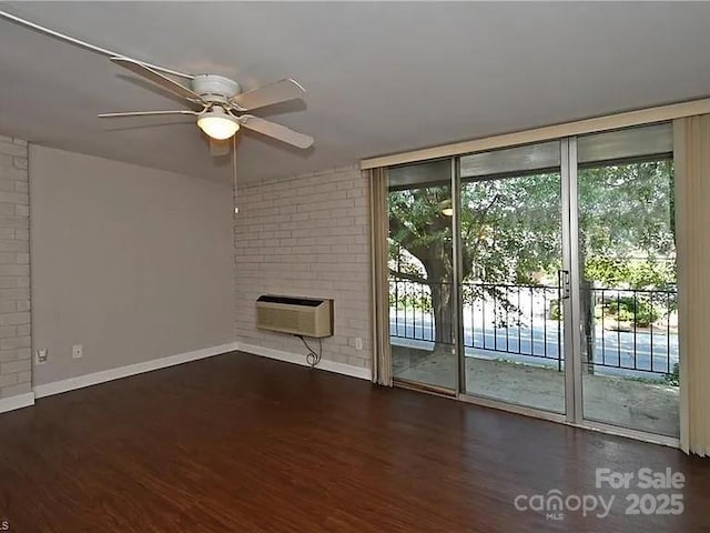 1807 S Hawthorne Rd, Winston Salem, NC 27103 - unfurnished living room with baseboards, a wall mounted AC, a ceiling fan, wood finished floors, and brick wall