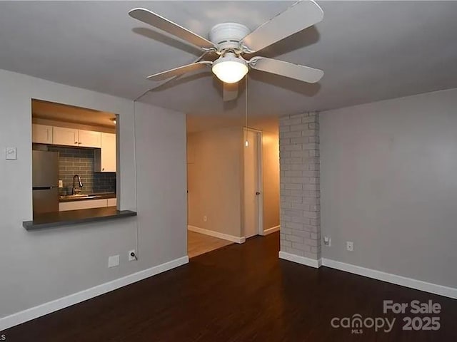 1807 S Hawthorne Rd, Winston Salem, NC 27103 - unfurnished living room with a sink, ceiling fan, wood finished floors, and baseboards