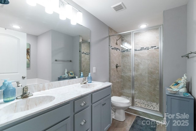 2737 Bobcat Rd, Heath Springs, SC 29058 - bathroom featuring toilet, double vanity, a stall shower, wood finished floors, and recessed lighting