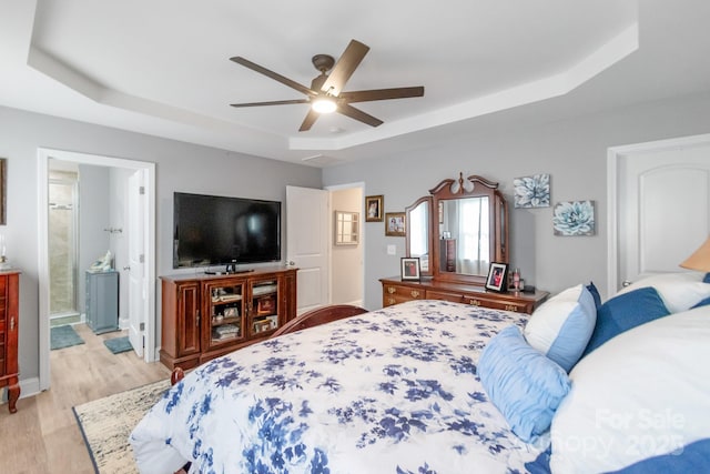 2737 Bobcat Rd, Heath Springs, SC 29058 - bedroom with a raised ceiling, light wood finished floors, a ceiling fan, and ensuite bath