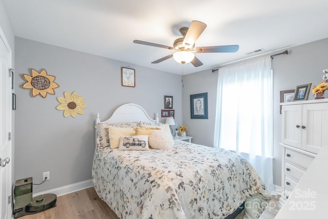 2737 Bobcat Rd, Heath Springs, SC 29058 - bedroom with light wood finished floors, multiple windows, baseboards, and ceiling fan