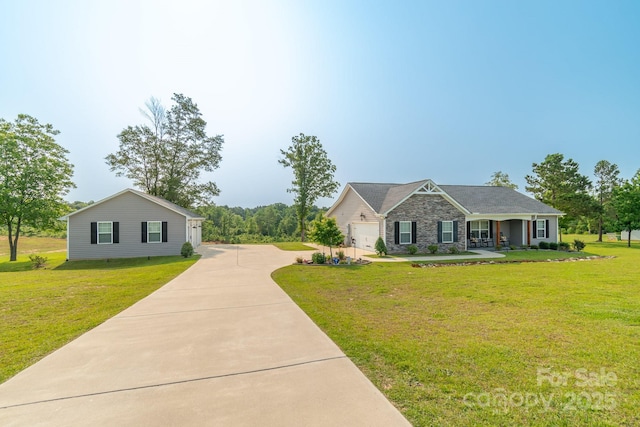 2737 Bobcat Rd, Heath Springs, SC 29058 - view of front of home with stone siding, a front lawn, concrete driveway, and covered porch