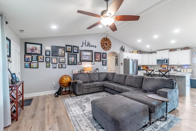 2737 Bobcat Rd, Heath Springs, SC 29058 - living area with arched walkways, lofted ceiling, a ceiling fan, light wood-style floors, and baseboards