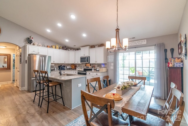 2737 Bobcat Rd, Heath Springs, SC 29058 - dining area with arched walkways, recessed lighting, a chandelier, light wood-type flooring, and vaulted ceiling