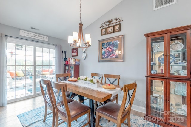 2737 Bobcat Rd, Heath Springs, SC 29058 - dining space featuring vaulted ceiling, wood finished floors, a chandelier, and baseboards