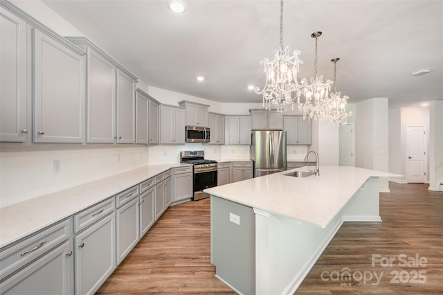 150 Haddonsfield Dr, Mooresville, NC 28115 - kitchen with stainless steel appliances, gray cabinets, a sink, light wood-type flooring, and recessed lighting