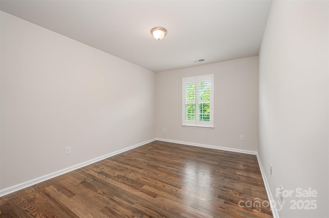 150 Haddonsfield Dr, Mooresville, NC 28115 - spare room with baseboards and dark wood-style flooring
