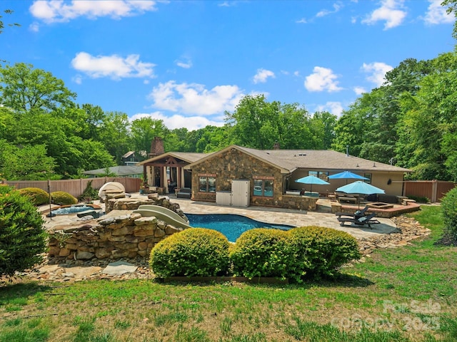 315 Mountainview Dr, Charlotte, NC 28270 - view of pool with a hot tub, a patio area, a fenced backyard, and a fire pit