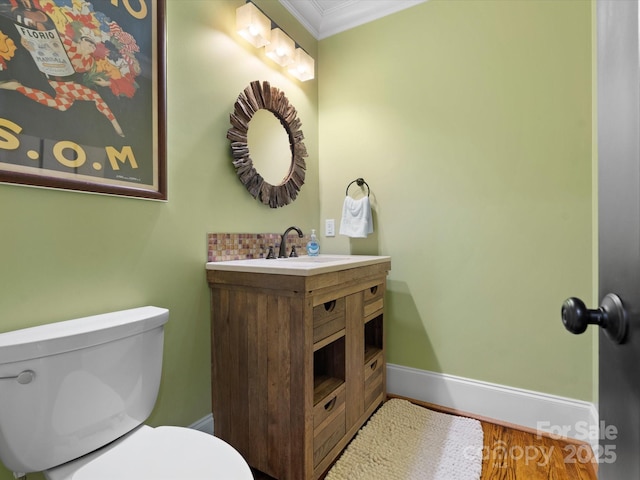 315 Mountainview Dr, Charlotte, NC 28270 - half bathroom with crown molding, toilet, vanity, baseboards, and wood finished floors