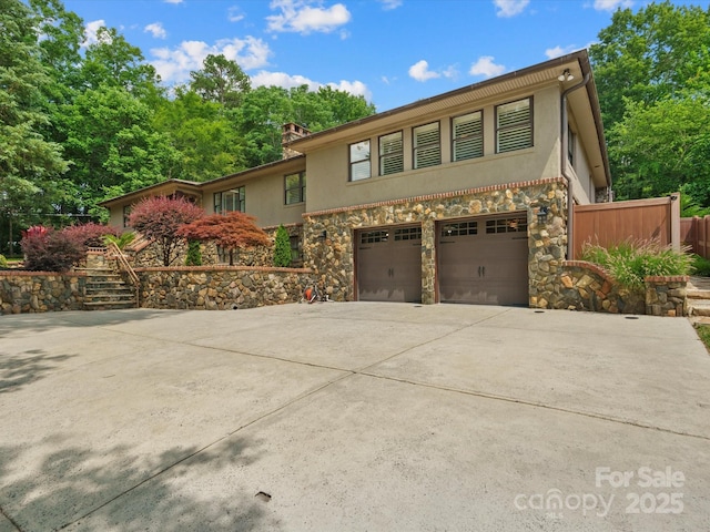315 Mountainview Dr, Charlotte, NC 28270 - view of front of property with an attached garage, stone siding, stucco siding, and concrete driveway