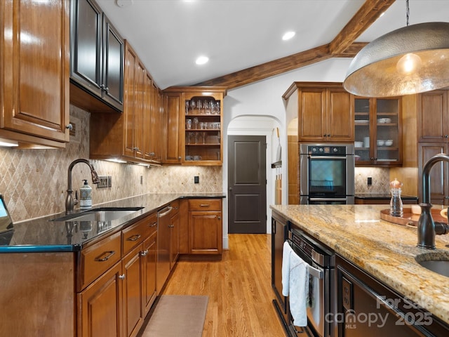 315 Mountainview Dr, Charlotte, NC 28270 - kitchen with a sink, light stone counters, double oven, light wood-type flooring, and backsplash