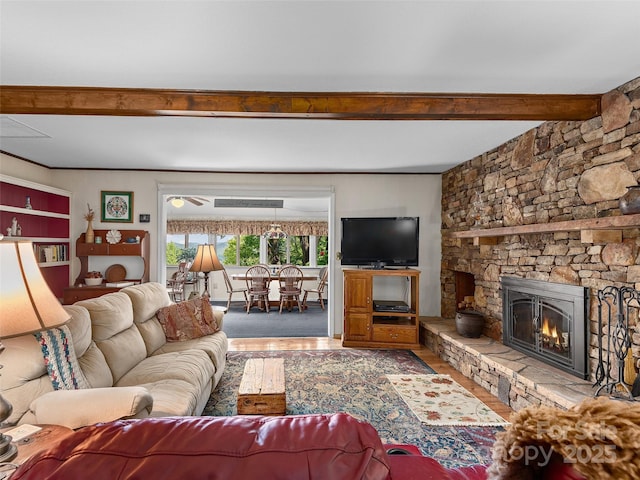 573 Valeria Ln, Pisgah Forest, NC 28768 - living room with wood finished floors, beamed ceiling, ceiling fan, and a fireplace