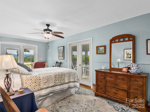 573 Valeria Ln, Pisgah Forest, NC 28768 - bedroom featuring french doors, access to outside, light wood-type flooring, wainscoting, and ceiling fan
