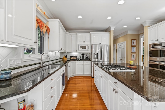4740 Myers Ln, Harrisburg, NC 28075 - kitchen featuring stainless steel appliances, white cabinetry, crown molding, recessed lighting, and light wood-style floors