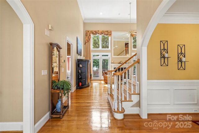 4740 Myers Ln, Harrisburg, NC 28075 - entrance foyer with arched walkways, wood finished floors, ceiling fan, stairway, and crown molding
