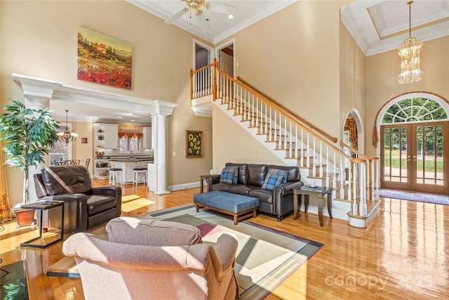 4740 Myers Ln, Harrisburg, NC 28075 - living area featuring wood finished floors, a towering ceiling, french doors, stairs, and ornamental molding