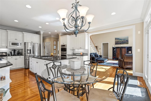 4740 Myers Ln, Harrisburg, NC 28075 - dining space featuring ornamental molding, a chandelier, light wood-style floors, recessed lighting, and stairs