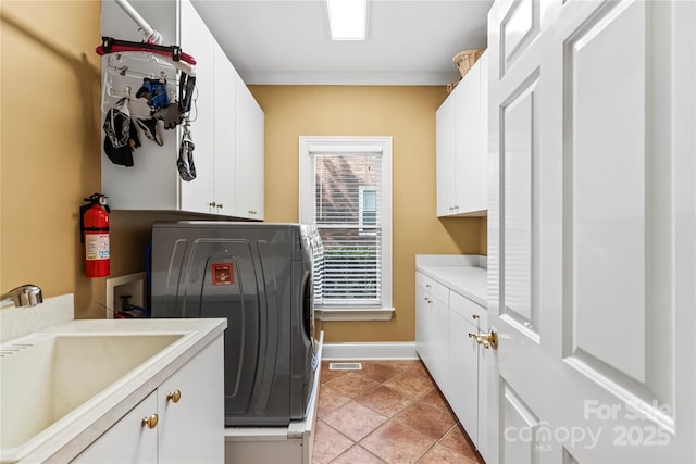 4740 Myers Ln, Harrisburg, NC 28075 - laundry room featuring washer / clothes dryer, cabinet space, and light tile patterned flooring