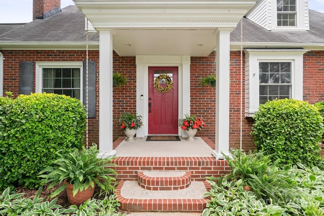 81 21st Ave NW, Hickory, NC 28601 - property entrance featuring brick siding, roof with shingles, and a chimney