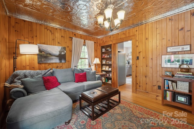 81 21st Ave NW, Hickory, NC 28601 - living area featuring wooden walls, a chandelier, an ornate ceiling, wood finished floors, and crown molding
