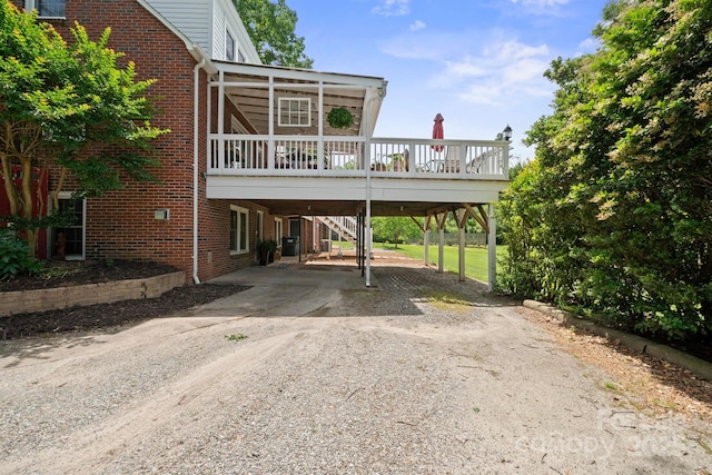81 21st Ave NW, Hickory, NC 28601 - view of front of house featuring driveway, a carport, brick siding, and a wooden deck