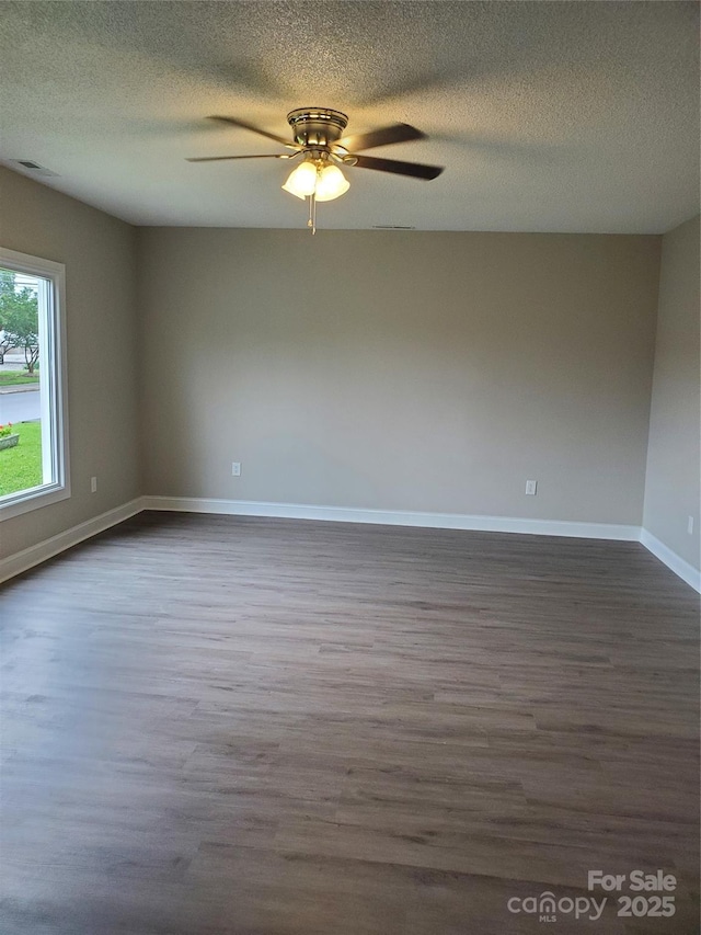 518 N Fulton St, Salisbury, NC 28144 - empty room with dark wood-style floors, ceiling fan, a textured ceiling, and baseboards