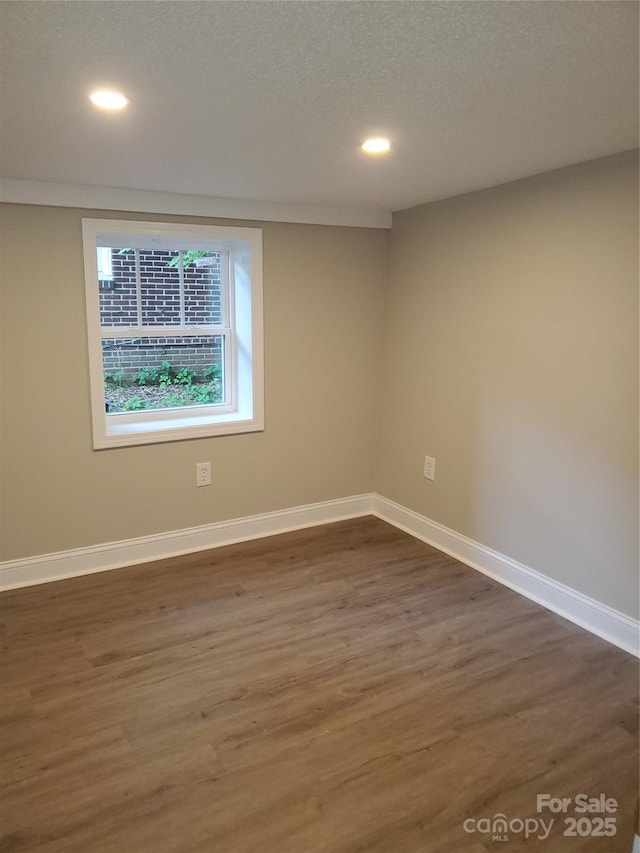 518 N Fulton St, Salisbury, NC 28144 - unfurnished room featuring dark wood-style floors, recessed lighting, and baseboards